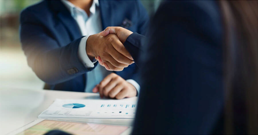 Business people shaking hands: BroadAspect and FluenStream Partnership