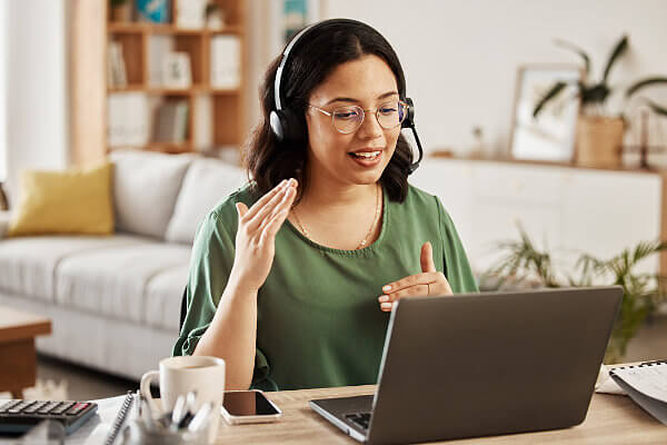 Woman with headset and laptop using SkyComm Connect